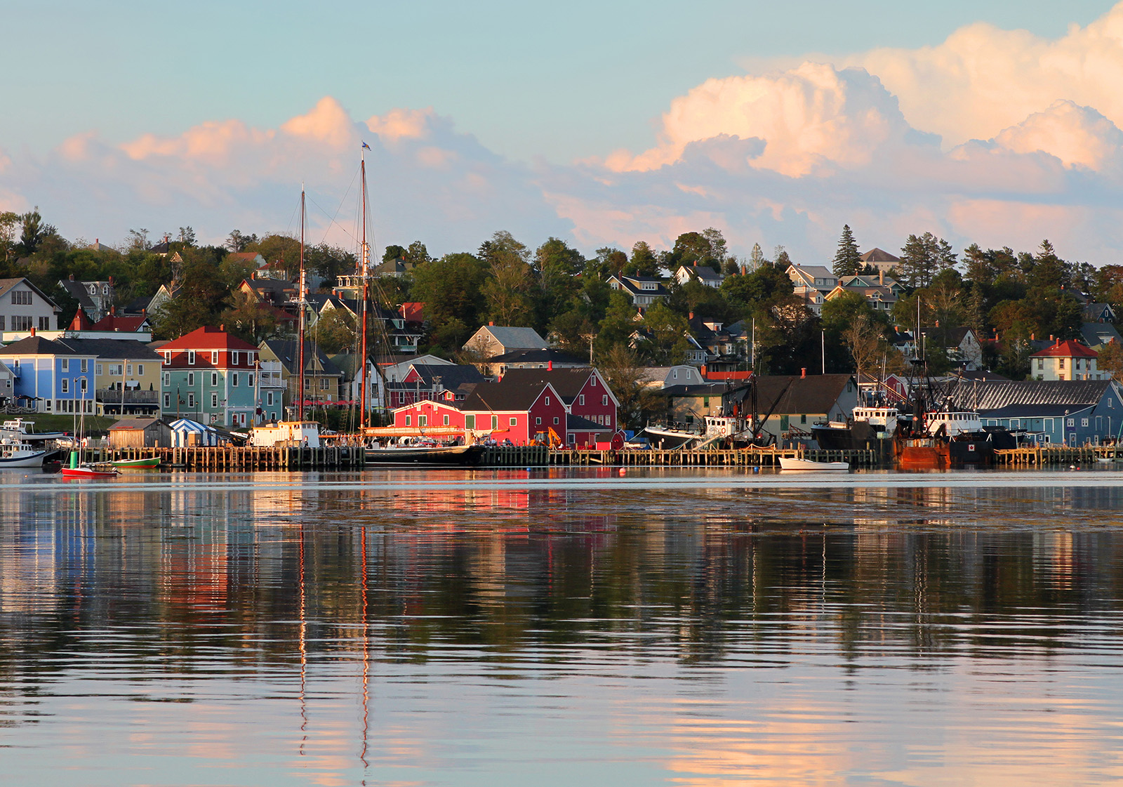 Sunset in Nova Scotia with vibrant red houses scattered throughout.
