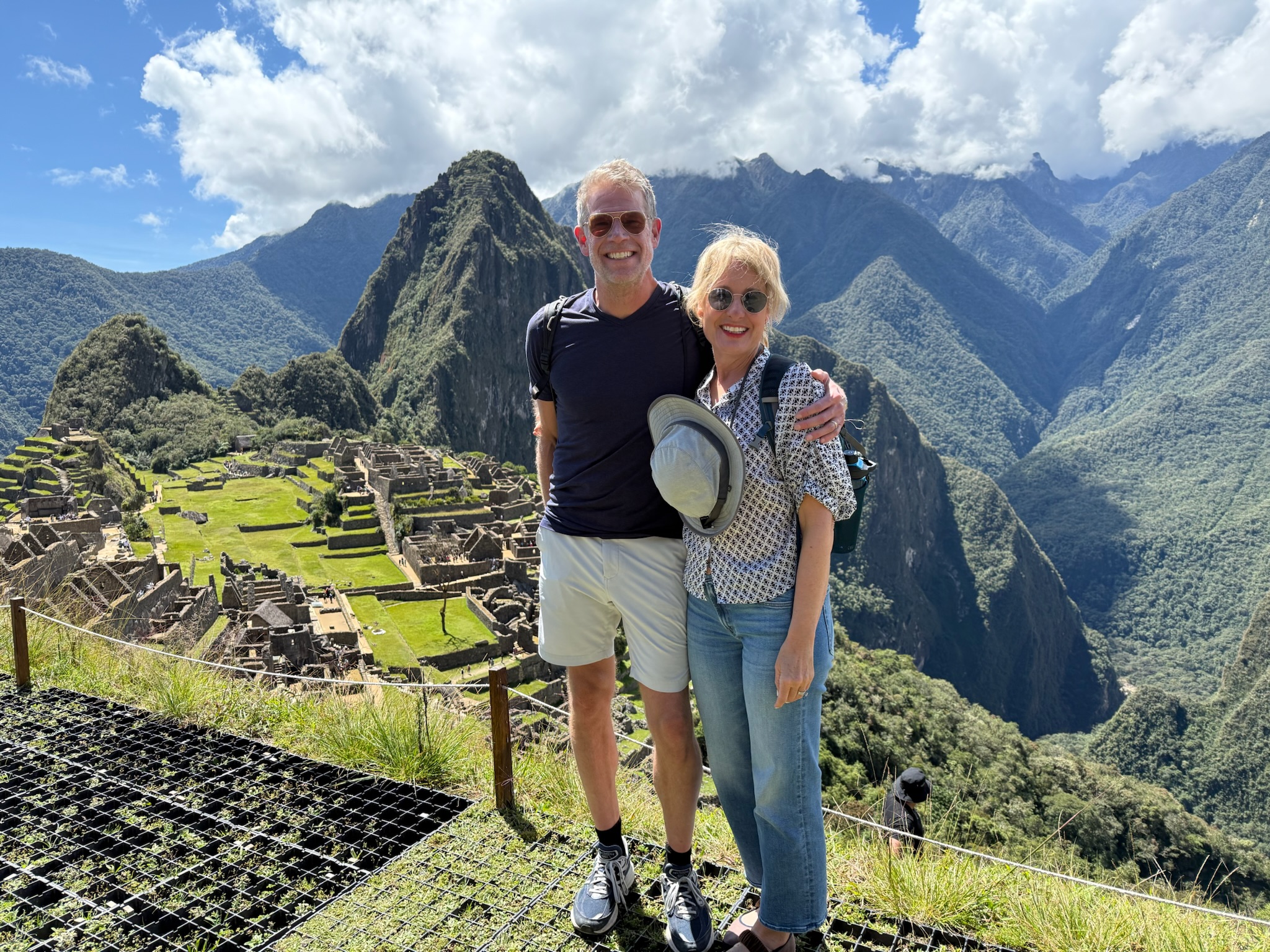Man and woman hugging in front of Machu Picchu