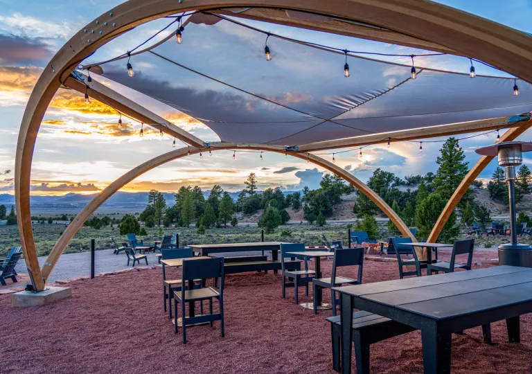 Outdoor patio with chairs and a tent with lights