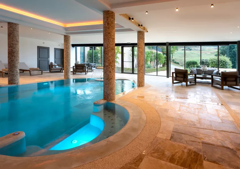 indoor pool with stone pillars