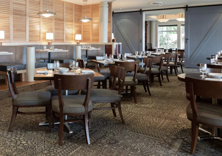 Indoor dining area with cushioned chairs and circular booths