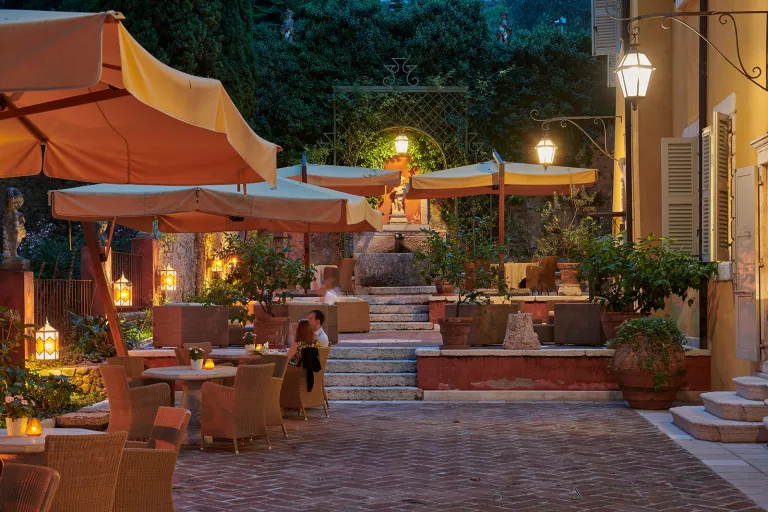 Outdoor patio with chair and tables with a couple dining