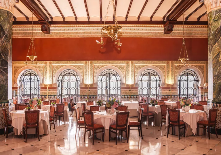 Indoor dining hall with tables and wooden chairs