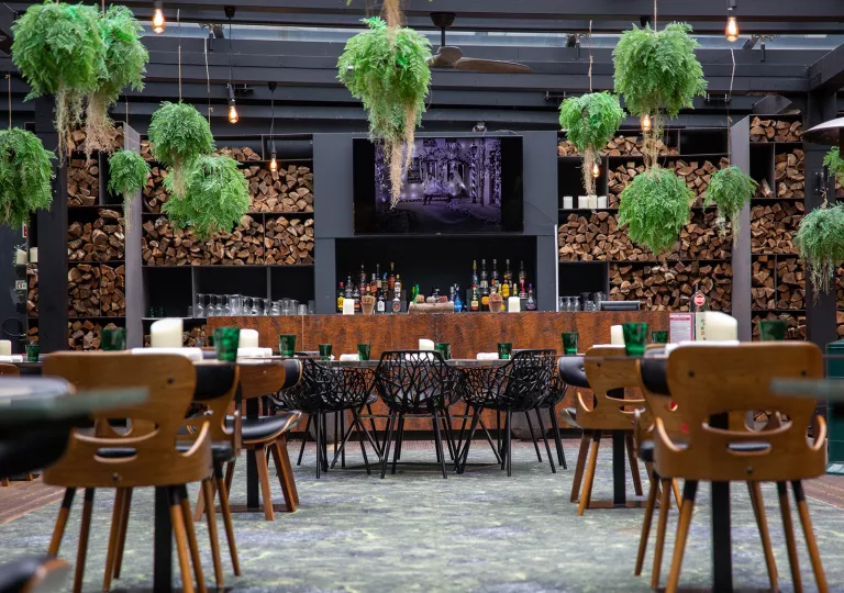 Outdoor dining area with a bar counter in the background
