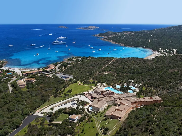 Hotel building surrounded by trees and the ocean