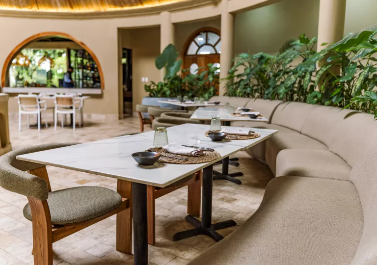 Dining hall with circular sofas and marble dining tables