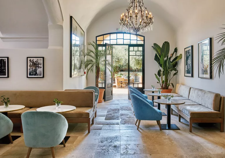 Seating area with cushioned sofas and circular tables