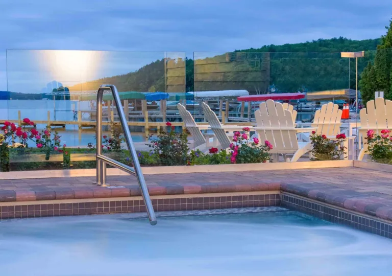 Outdoor pool with glass barricades and the ocean in the background