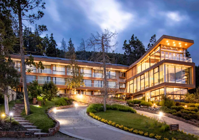 Hotel Alto Traful in Villa Traful, Argentina, featuring a modern architectural design with extensive glass walls and wooden paneling.