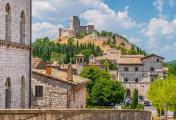 Wide shot of brick villages, large brick building on hilltop.