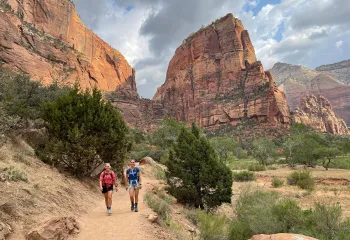 Hikers walking on trail in canyon