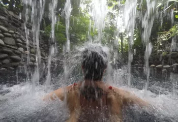 Person standing under an active waterfall
