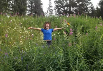 Backroads trip leader with wildflowers in Alaska