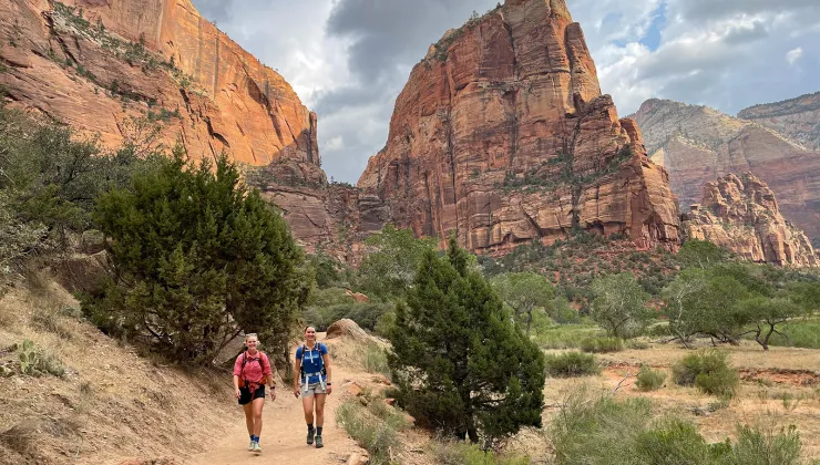 Hikers walking on trail in canyon
