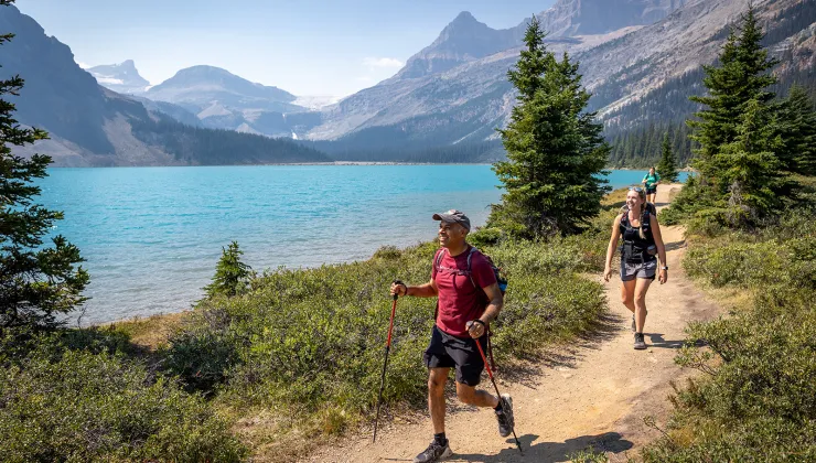 hikers walking by a lake