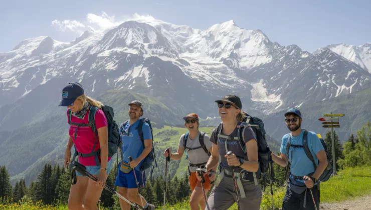Group of people wearing backpacks, hiking on a trail