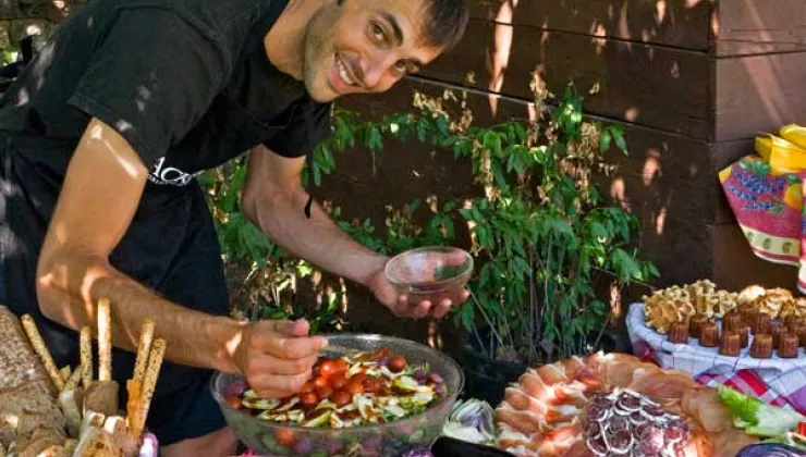 `A Backroads leader prepares a spectacular picnic lunch, featuring Spanish ham –- Jamón
