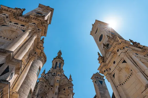 Ground shot looking up at the Château de Chambord spires.
