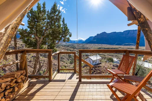 Wooden patio of a luxury hut, with a large valley in the background