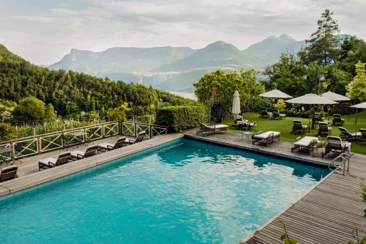 pool with lounge chairs and view of mountains