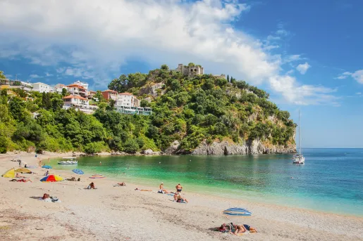 Sunny beach with a cliff in the distance