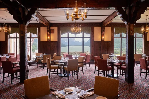 Indoor dining area with wine glasses and yellow and red seats