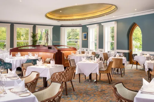 Indoor dining area with white table cloths on all dining tables