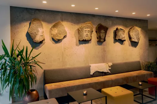couch with stone statues hung above it 