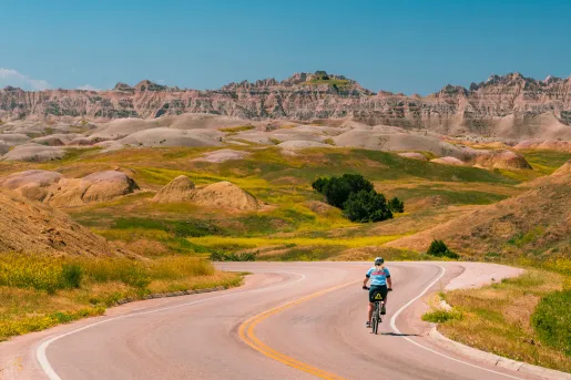 Backroads guest biking down a road