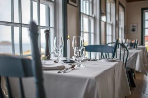 dining room table with setting next to window