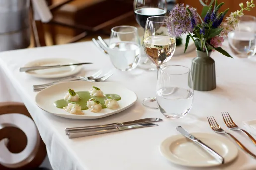 dining table set with plate and wine glass