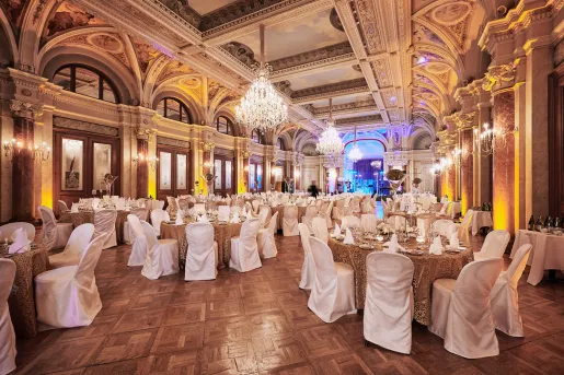 Banquet hall with circular tables and white chairs around each table