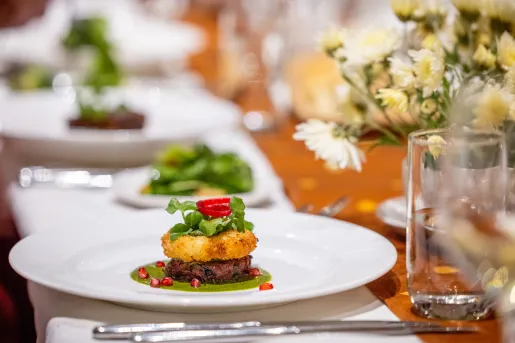 Plate full of fancy food on a dining table