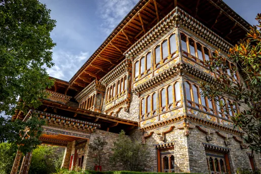Outdoor view of three-story hotel building with stone walls