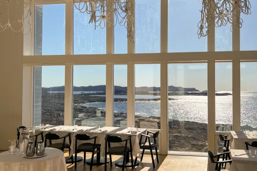 dining room with window overlooking water