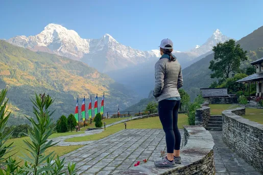 Woman overlooking hills and mountains in the distance
