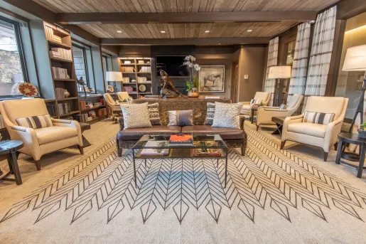 living room with wood paneling and large carpet