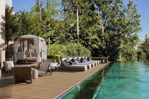 swimming pool with lounge chairs next to it