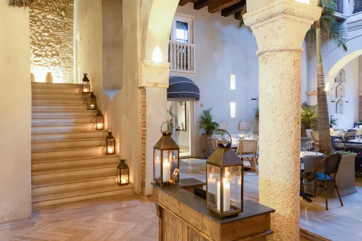 Indoor lounge with candles along a staircase to the left