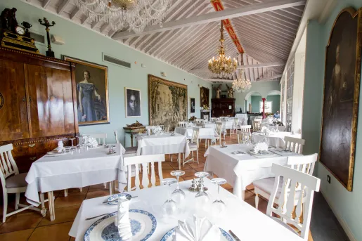 Dining hall with white tables and white and blue plates