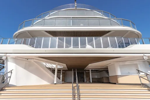 Yacht with a large staircase and three glass balconies on top