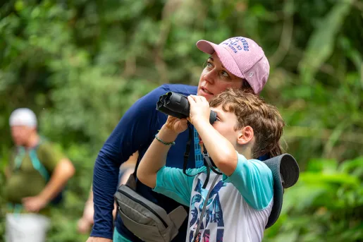Mom and son looking through a pair of binoculars