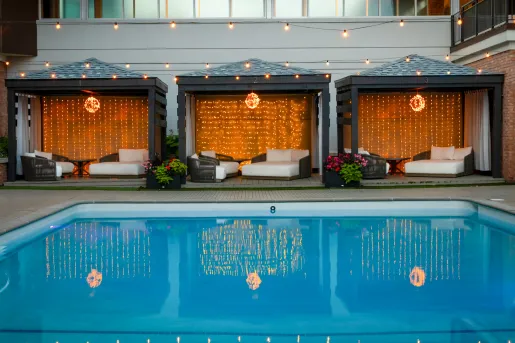Outdoor pool with cushioned beds surrounding