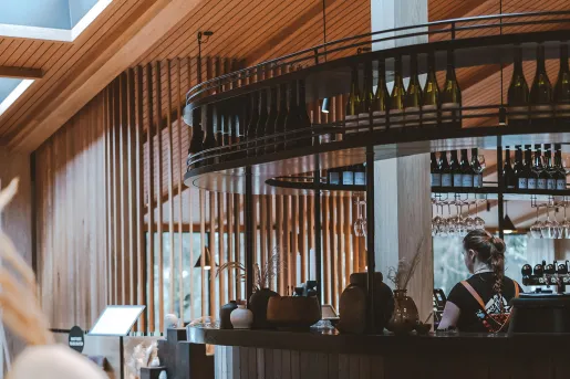 Bar with a bartender behind the counter cleaning glasses