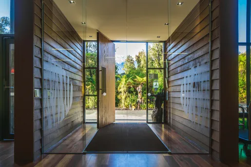Doorway entry with a glass door and wooden panels on either side