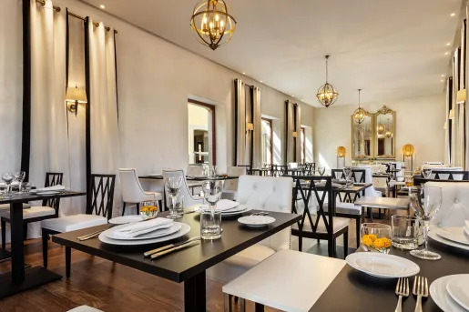 Restaurant with square black tables with white plates