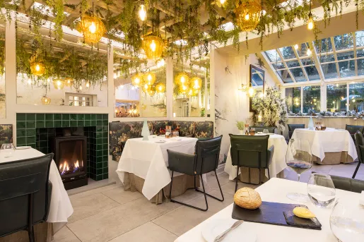 Dining hall with square tables and green leather chairs