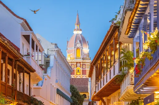 Alleyway of tall buildings with a capital building in the center