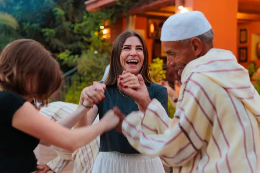 Women smiling while dancing in a circle