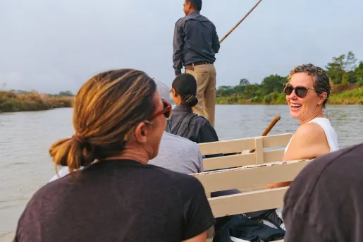 Group of women smiling while riding on a boat